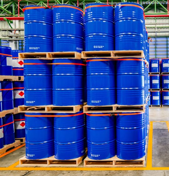 blue barrels stacked on pallets